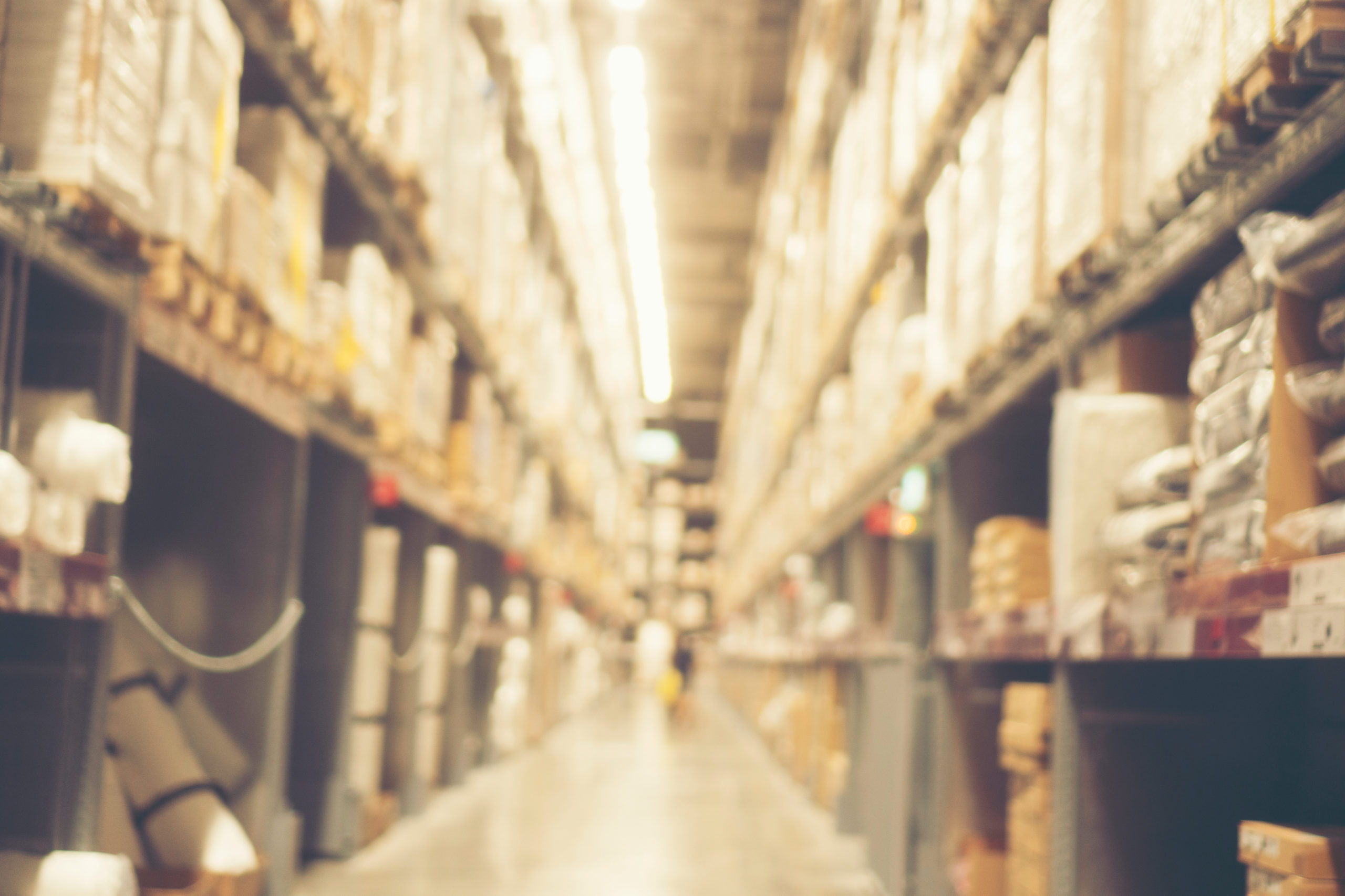 Abstract blurry background of warehouse storing with a lot of large box stack