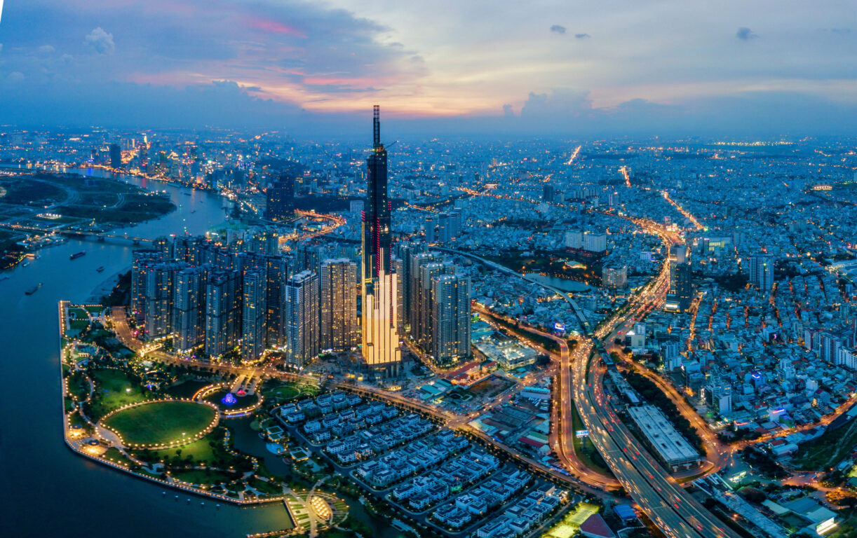 Aerial cityscape of Saigon at beautiful nightfall sky in evening. Highways weave around the city in Vietnam.