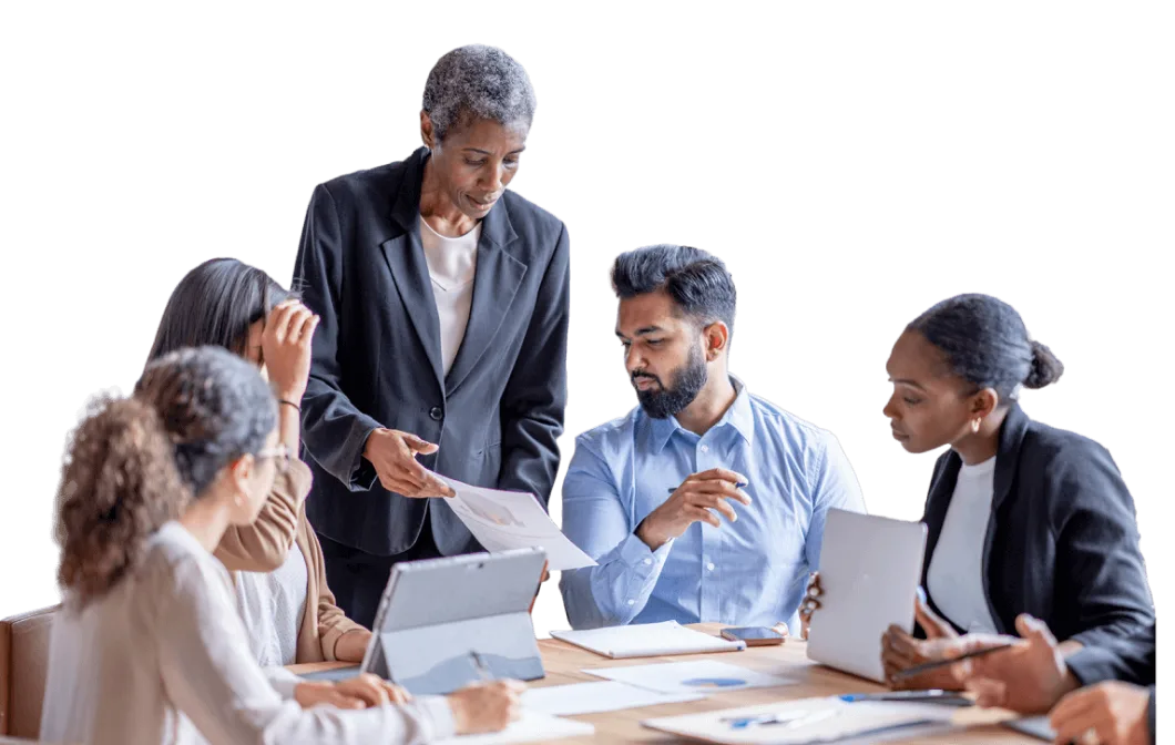 Diverse business team collaborating and reviewing documents during a meeting